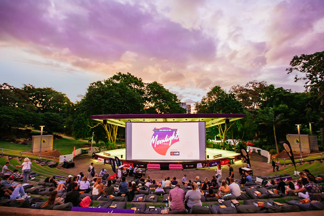 an outdoor ampitheatre facing a large screen
